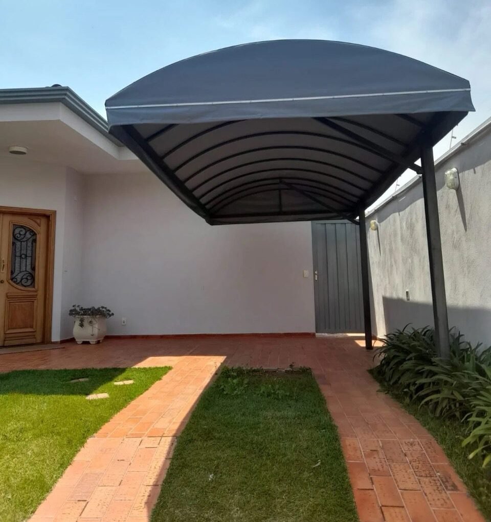 Toldo e cobertura instalada em área externa, oferecendo proteção contra sol e chuva com estrutura resistente e acabamento profissional. - Início